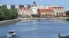 FILE - A man sits on a pole along the river in Kaliningrad on June 18, 2018, during the Russia 2018 World Cup football tournament. 