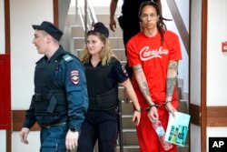 WNBA star and two-time Olympic gold medalist Brittney Griner is escorted to a courtroom for a hearing, in Khimki just outside Moscow, Russia, July 7, 2022.