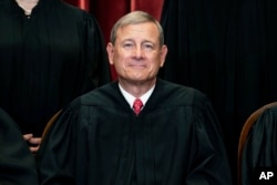 FILE - Chief Justice John Roberts sits during a group photo at the Supreme Court in Washington, April 23, 2021.