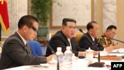 FILE - This undated picture released June 24, 2022, by the Korean Central News Agency shows North Korean leader Kim Jong Un, center, attending a meeting of the Eighth Central Military Commission of the Workers' Party of Korea in Pyongyang.