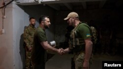 Ukraine's President Volodymyr Zelenskiy awards a Ukrainian service member, as Russia's attack on Ukraine continues, at an unknown location in southern Ukraine, June 18, 2022. (Ukrainian Presidential Press Service/Handout via Reuters)