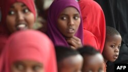 Young Somali refugees sit with their families, who have volunteered to be repatriated back to Somalia from the Dadaab refugee camp in northern Kenya on Dec. 19, 2017.