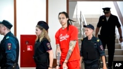 FILE: WNBA star and two-time Olympic gold medalist Brittney Griner is escorted to a courtroom for a hearing, in Khimki just outside Moscow, Russia, Thursday, taken 7.7.2022