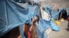 FILE - A child peeks from a tent at the internally displaced persons camp of Guyah, 100 kms from Semera, Afar region, Ethiopia, May 17, 2022.