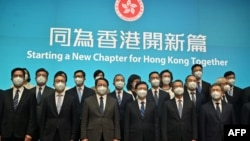 Hong Kong's Chief Executive-elect John Lee (front 3rd R) poses for a photo with his newly-appointed cabinet at the central government headquarters in Hong Kong on June 19, 2022. 