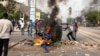 Protesters throw a dumpster on a fire in Dakar, Senegal Friday, June 17, 2022. (Annika Hammerschlag/VOA)