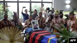 Xukuru's Indigenous people sing a prayer in honor of the Brazilian Indigenous expert Bruno Pereira next to his coffin during his funeral at the Morada da Paz Cemetery in Paulista, Pernambuco state, Brazil, on June 24, 2022.