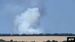 FILE - This photograph taken on July 7, 2022 shows smoke billowing after shelling on the outskirts of the city of Sloviansk. 