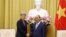 Australian Foreign Minister Penny Wong, left, and Vietnamese President Nguyen Xuan Phuc shake hands in Hanoi, Vietnam Monday June 27, 2022. (AP Photo/ Hoang Duong)