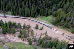 This aerial photo provided by the National Park Service shows a flooded out North Entrance Road, of Yellowstone National Park in Gardiner, Mont., on June 13, 2022. (Jacob W. Frank/National Park Service via AP)
