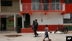 A police officer patrols in Cerocahui, Mexico, June 22, 2022. The two elderly priests were killed inside the church, where a man pursued by gunmen apparently sought refuge, the religious order´s Mexican branch announced Tuesday.