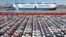 FILE - In this photo released by Xinhua News Agency, an aerial view shows manufactured vehicles before being loaded onto a cargo ship at the Yantai Port in eastern China's Shandong Province, Dec. 7, 2021.