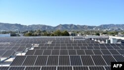 Solar panels are seen on the roof of a building in Los Angeles, California, on June 18 2022.
