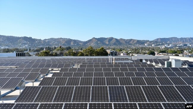 Solar panels are seen on the roof of a building in Los Angeles, California, on June 18 2022.