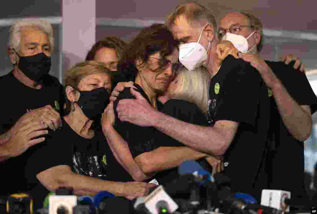 Relatives mourn as Alessandra Sampaio, center, embraces her sister-in-law Sian Phillips after speaking to the media during the funeral of her husband British journalist Dom Phillips at the Parque da Colina cemetery in Niteroi, Brazil.&nbsp;Family and friends paid their final respects to Phillips who was killed in the Amazon region along with the Indigenous expert Bruno Pereira.