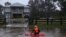 James Taylor paddles a kayak down a flooded residential street on his way to check on a friend's home, after rains inundated the area with floodwater in the McGraths Hill suburb of Sydney, Australia, on July 6, 2022. 
