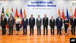 In this photo provided by Indian Foreign Minister S. Jaishankar's Twitter handle, Jaishankar, center, stands with Southeast Asian foreign ministers at the start of a meeting in New Delhi, India, Thursday, June 16, 2022.