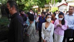 Cambodian people line up before voting at a polling station in Takhmua, in Kandal province, southeast of Phnom Penh, Cambodia, June 5, 2022.