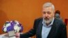 Nobel Peace Prize winner Dmitry Muratov, editor-in-chief of the influential Russian newspaper Novaya Gazeta, poses for a picture next to his 23-karat gold medal before it is auctioned at the Times Center, June 20, 2022, in New York.