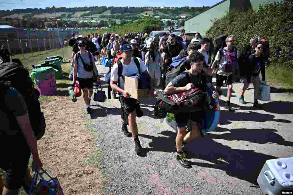 Revelers arrive for the Glastonbury Festival at Worthy Farm in Somerset, Britain.
