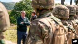 Britain's Defense Secretary Ben Wallace meets new recruits of the Ukrainian army being trained by U.K. military specialists during a visit to the training camp near Manchester, England, July 7, 2022.