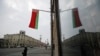 FILE - A Belarusian national flag flutters over a street in Minsk, Belarus, Feb. 16, 2022.