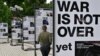 A woman visits the photo exhibition 'The war is not over' opened in the Taras Shevchenko park in Kyiv on June 23, 2022.