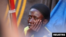 A woman looks after people claimed to feel not safe because of xenophobic attacks in central Cape Town, South Africa, March 1, 2020.