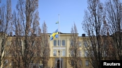FILE - Swedish flag is seen at half mast outside Malmo Latin School, the day after two women died from "violence", according to police, in Malmo, Sweden March 22, 2022. (TT News Agency/Johan Nilsson via Reuters)