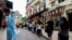 FILE - People queue for COVID-19 testing in Macau, China, June 20, 2022. Testing for all residents will take place three times this week across the city, with people also required to take rapid antigen tests in between. 