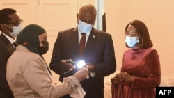 File- Lucara Diamond Botswana managing director Naseem Lahri (2nd L) shows Botswana President Mokgweetsi Masisi (2nd R) and First Lady Neo J Masisi a 1,174-carat diamond in Gaborone, Botswana, on July 7, 2021, that the Lucara Botswana found in June 2021. 