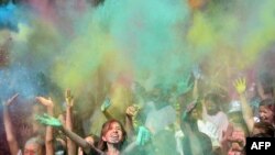 People throw colored powder during the Holi Festival of Colors in Bishkek, Kyrgyzstan.