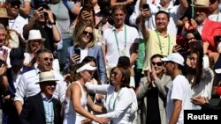 Kazakhstan's Elena Rybakina celebrates in the stands with coach Stefano Vukov after winning the women's singles final against Tunisia's Ons Jabeur, London, Britain - July 9, 2022.