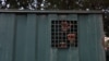 FILE—The hands of recaptured inmates are seen inside a prison vehicle in Abuja, Nigeria on July 6, 2022, after suspected Boko Haram gunmen attacked the Kuje Medium Prison. 