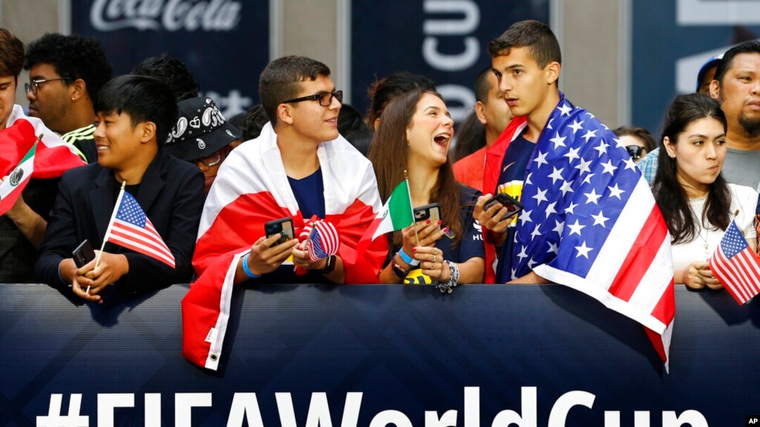 Fans wait along 6th Avenue for FIFA's announcement of the names of the host cities for the 2026 World Cup soccer tournament, June 16, 2022, in New York.