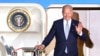 President Joe Biden waves as he leaves Air Force One after arriving at Franz-Josef-Strauss Airport near Munich, Germany, June 25, 2022, ahead of the G7 summit. 
