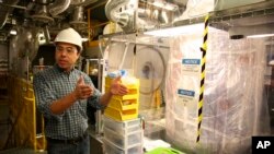 FILE - Aaron Manalaysay, the physics coordinator of Lawrence Berkeley National Lab's experiment, explains how the underground detector will interact with dark matter in the Sanford Underground Research Facility in Lead, South Dakota, on Dec. 8, 2019.