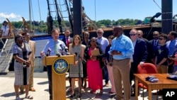 During a ceremony in front of the replica Amistad slave ship, Connecticut Gov. Ned Lamont, speaks June 10, 2022, in New London, Conn., before signing a copy of legislation that establishes a new legal state holiday on June 19 to be known as Juneteenth Independence Day.
