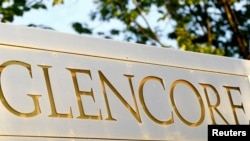 FILE - The logo of commodities trader Glencore is pictured in front of the company's headquarters in Baar, Switzerland, July 18, 2017. 