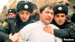 FILE - Police detain an opposition activist in Baku, March 11, 2011. Anti-government activists then used social media to call for street protests in the oil-producing Muslim state. Facebook and YouTube are now the most popular social media platforms in the country, says independent journalist Kamran Mahmudov, and independent internet TV stations are concentrated on those platforms.