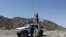 A Taliban member tries to get a communication signal on top of a vehicle in the quake-hit area of Wor Kali village in the Barmal district of Paktika province, Afghanistan, June 25, 2022. 