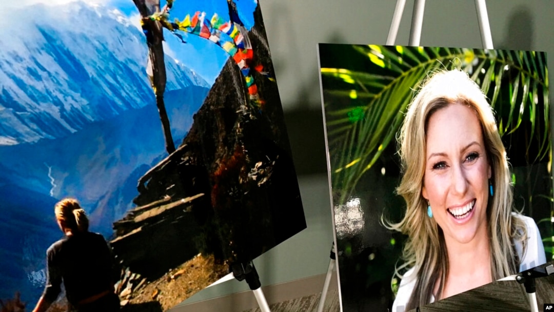 FILE - In this July 23, 2018, photo, posters of Justine Ruszczyk Damond are displayed at a news conference by attorneys for her family in Minneapolis.