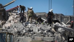 Ukrainian State Emergency Service firefighters clear debris at damaged residential building in the town of Serhiivka, located about 50 kilometers (31 miles) southwest of Odesa, Ukraine, July 1, 2022.