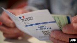 This photograph taken on June 19, 2022, shows a French electoral card in Carhaix-Plouguer, western France, during the second round of French legislative elections. 