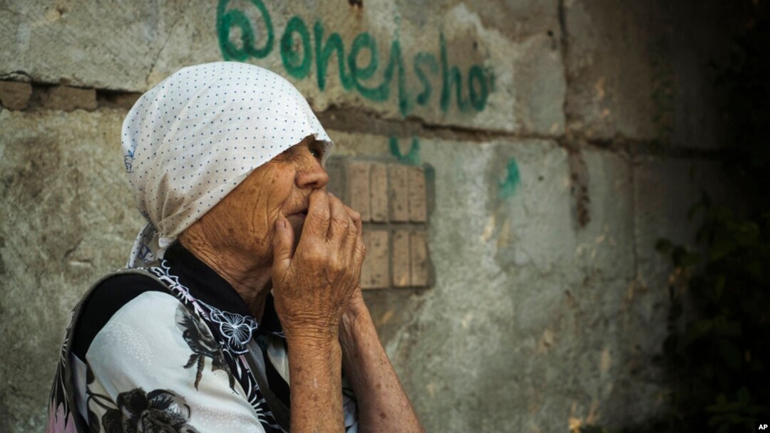 An elderly Ukrainian woman looks on after Russian shelling in Mykolaiv, Ukraine, June 29, 2022. 