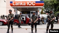 Air Force members stand guard at a Lanka IOC fuel station (Indian Oil Corporation) as people queue up to buy fuel due to fuel shortage, amid the country's economic crisis, in Colombo, Sri Lanka, July 6, 2022. 