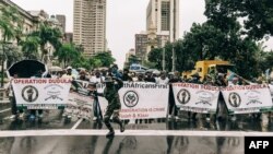 FILE - Members of "Operation Dudula" chant anti-migrant slogans as they march in Durban, on April 10, 2022. Protesters in South Africa have staged demonstrations against undocumented migrants in what they have dubbed Operation Dudula, Zulu for "drive back."