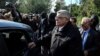 FILE - Leader of the far-right Golden Dawn party Nikos Mihaloliakos is escorted as he leaves his home, after the party was declared a criminal organization by a court in Athens, Greece, Oct. 22, 2020.