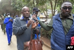A member of the Maa unity agenda (L) is arrested during the protest in Nairobi, condemning the forceful eviction of the Loliondo Ngorongoro Maa community by the republic of Tanzania, on June 17, 2022.