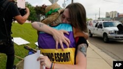 Derenda Hancock, co-director of the Jackson Women's Health Organization clinic patient escorts, better known as the Pink House defenders, left, hugs a tearful abortion rights supporter Sonnie Bane, outside the Jackson Women's Health Organization clinic in the U.S. state of Mississippi.